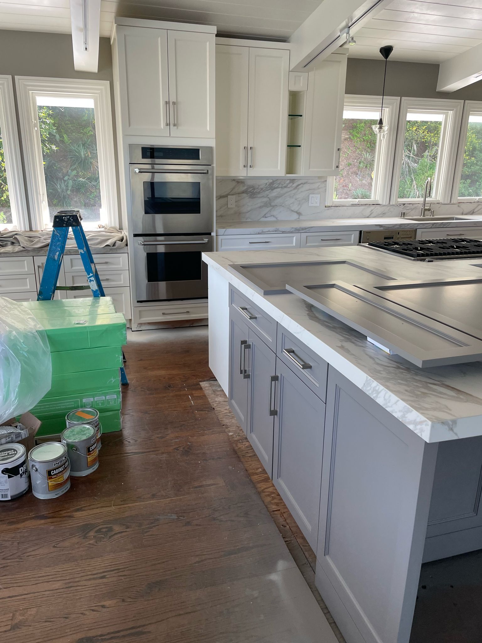 Bright Kitchen Remodel With White Cabinets and Stainless Steel Appliances