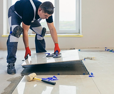 Worker Installing Floor Tiles During Home Remodeling Fairfield CA