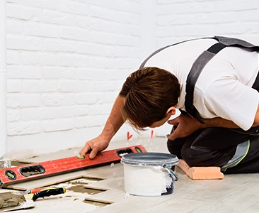 Worker Installing Tiles During Bathroom Remodeling Fairfield CA