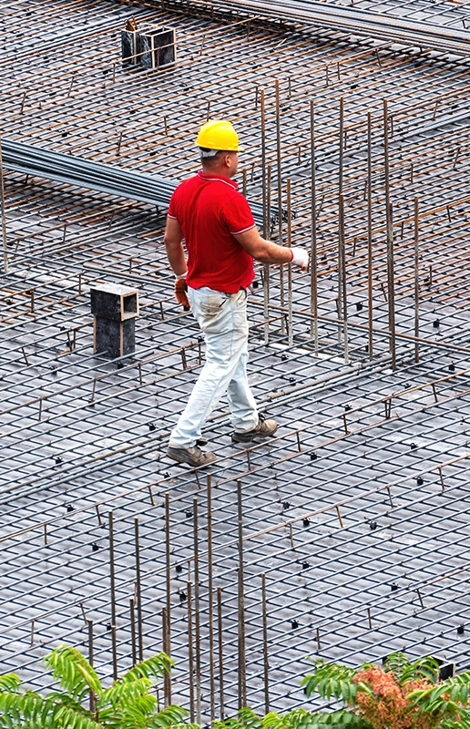 Construction Worker Inspecting Reinforcement Bars for Custom Deck Construction Fairfield CA