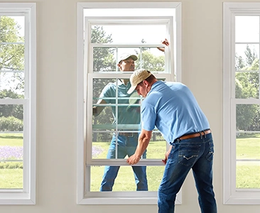 Worker Installing Window in a Bright Room with Garden View