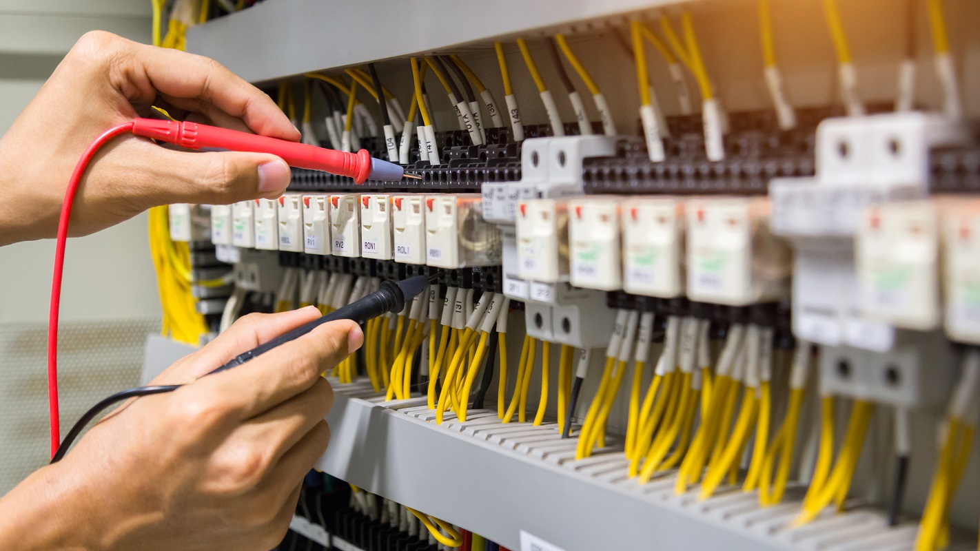 Electrician Testing Circuit Breaker Panel with Multimeter in Fairfield CA