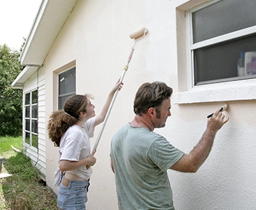 Father and Daughter Painting House Exterior Together in Fairfield CA