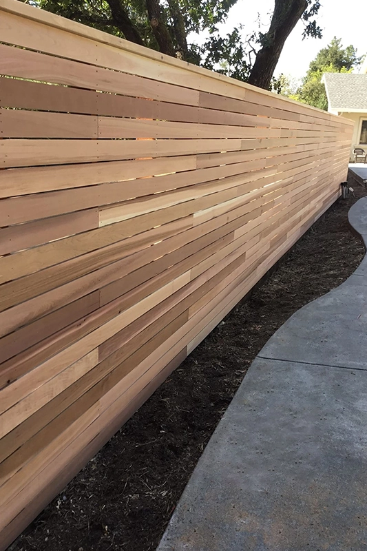 Wooden Privacy Fence Along Curved Concrete Path in Fairfield CA