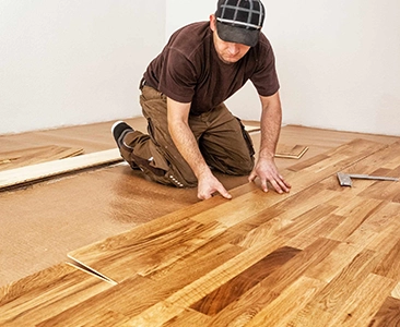 Worker Installing Hardwood Flooring in Home Remodeling Fairfield CA