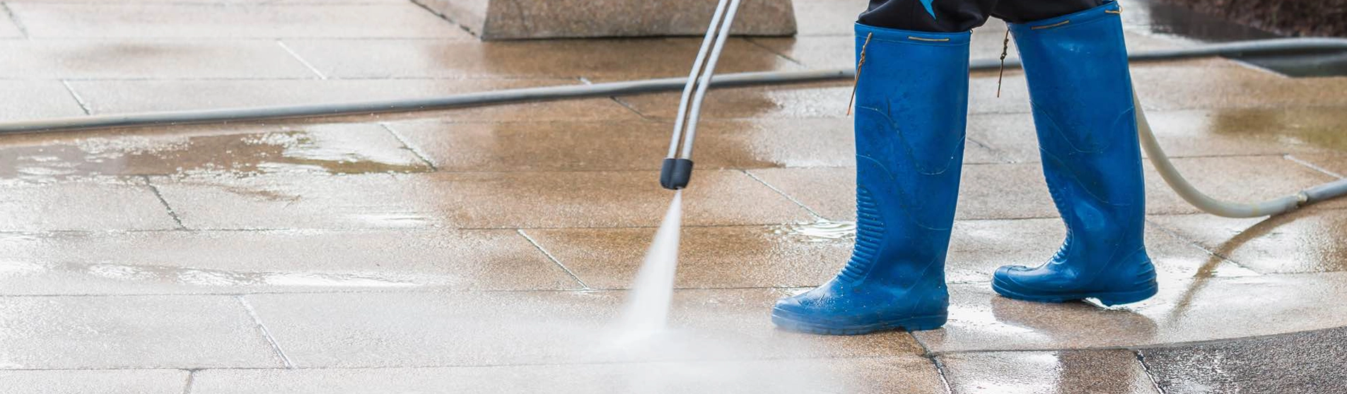 Person Pressure Washing Patio with Blue Boots in Fairfield CA