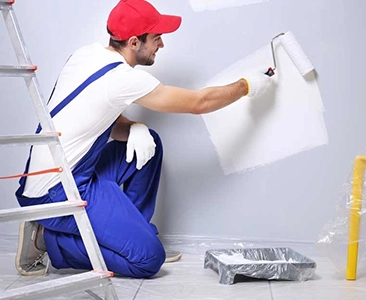 Man Painting Wall with Roller During Bathroom Remodeling Fairfield CA