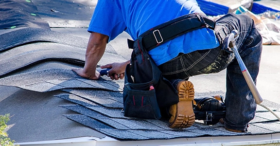 Worker Installing Shingles on a Roof in Fairfield CA
