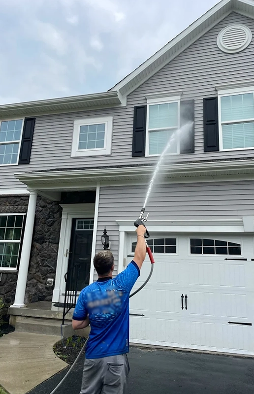 Worker Pressure Washing House Exterior in Fairfield CA